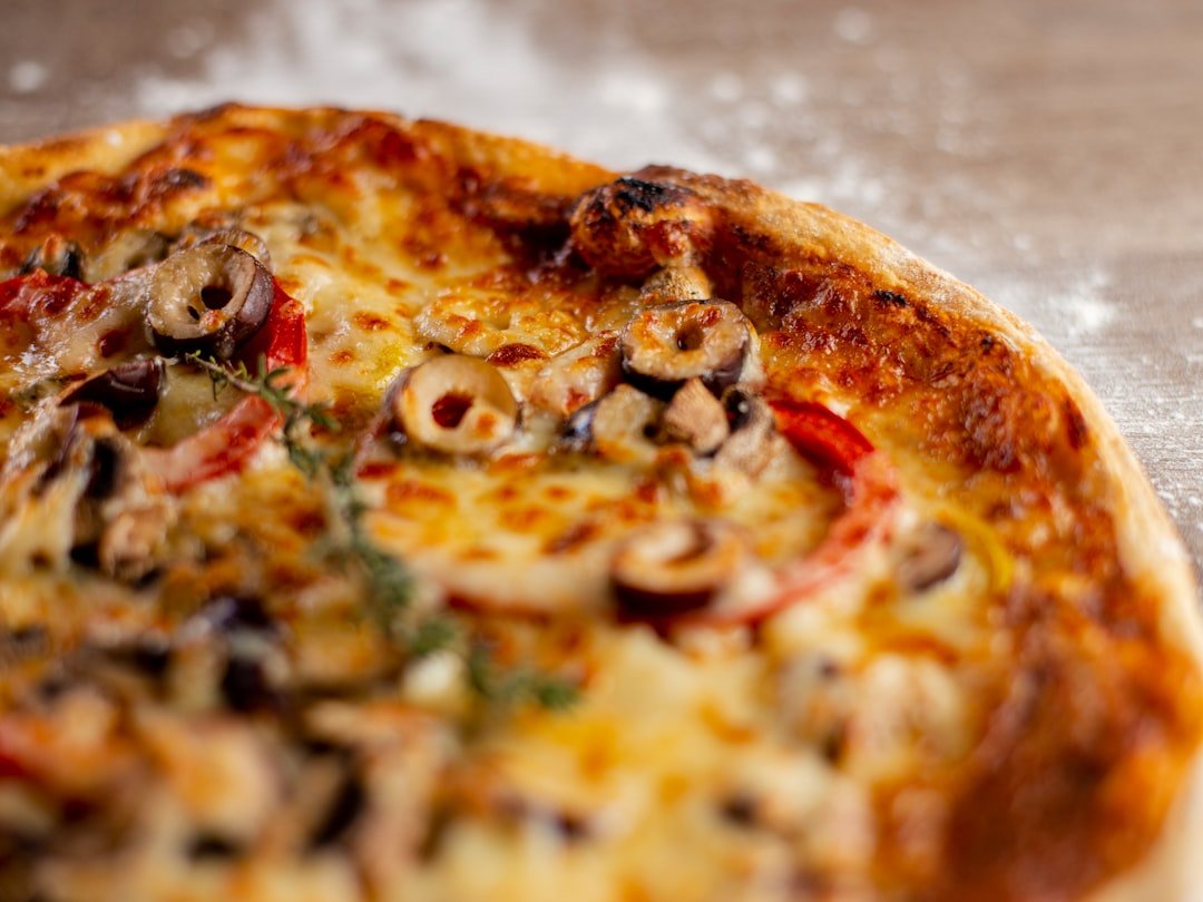 a-close-up-of-a-delicious-pizza-with-olives-and-cheese-y4u1iccqufc